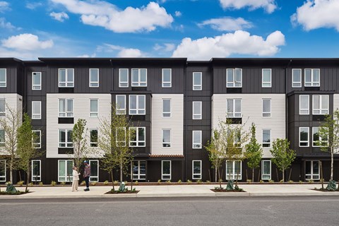 a rendering of a three story apartment building on a city street