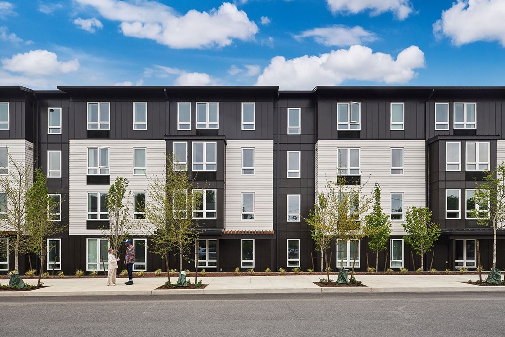 a rendering of a three story apartment building on a city street