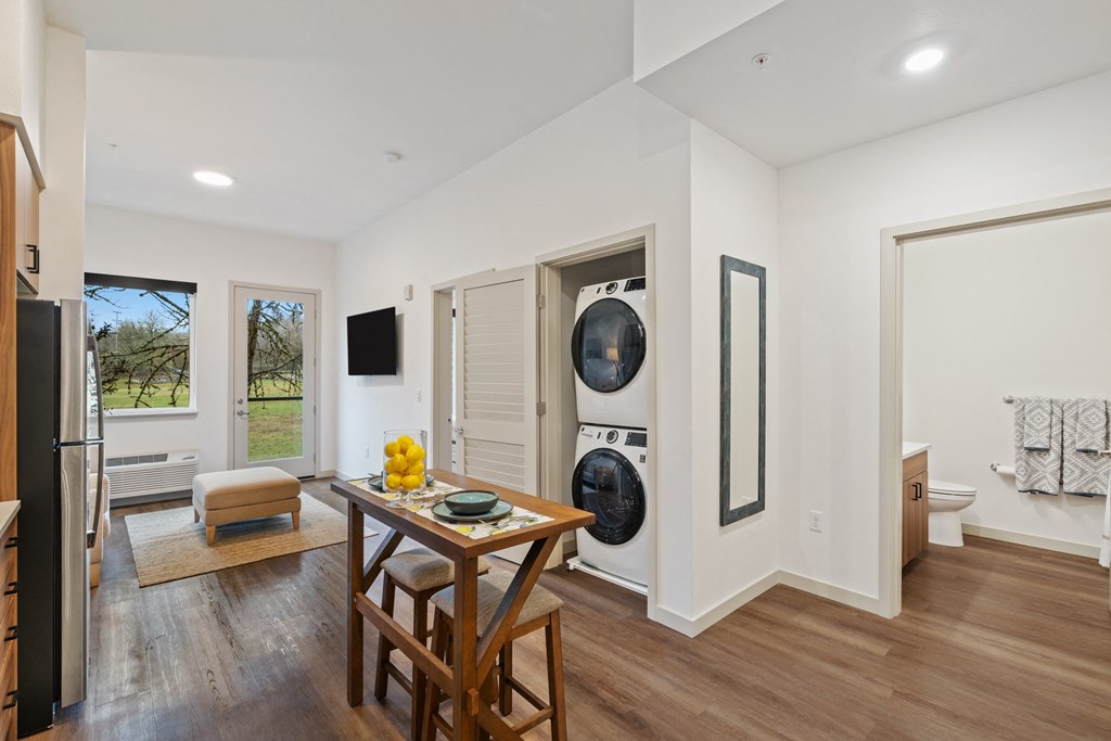 a living room with a table and a washing machine