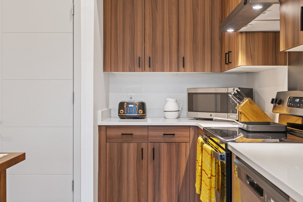 a kitchen with a stove top oven and a microwave