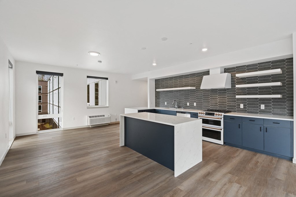 a large kitchen with blue cabinets and a white counter top
