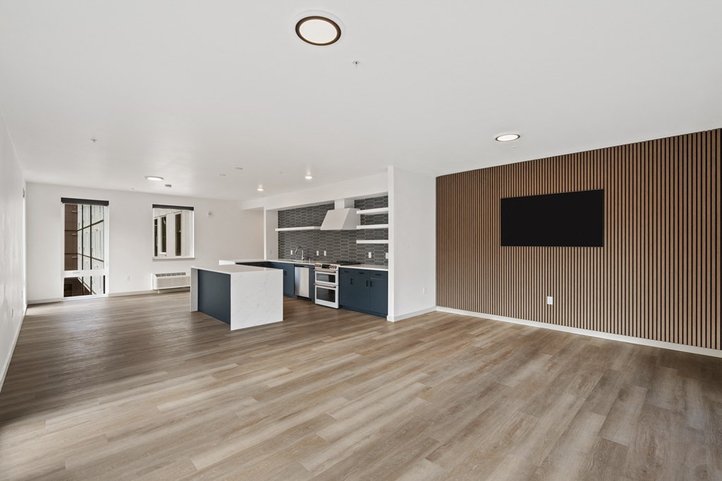 a living room with a kitchen and a tv