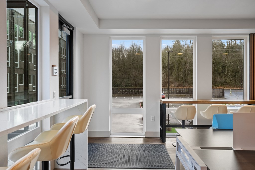 a living room with a table and chairs and sliding glass doors