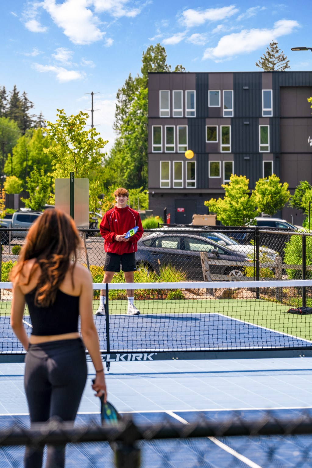 a man and woman playing tennis on a tennis court