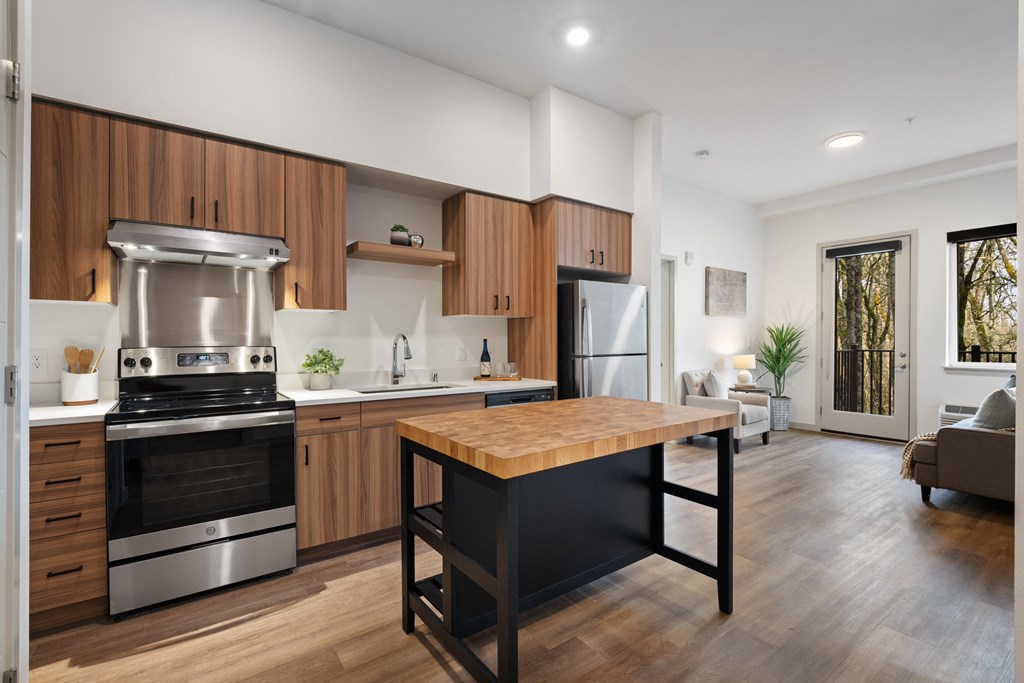 a kitchen with stainless steel appliances and a wooden table