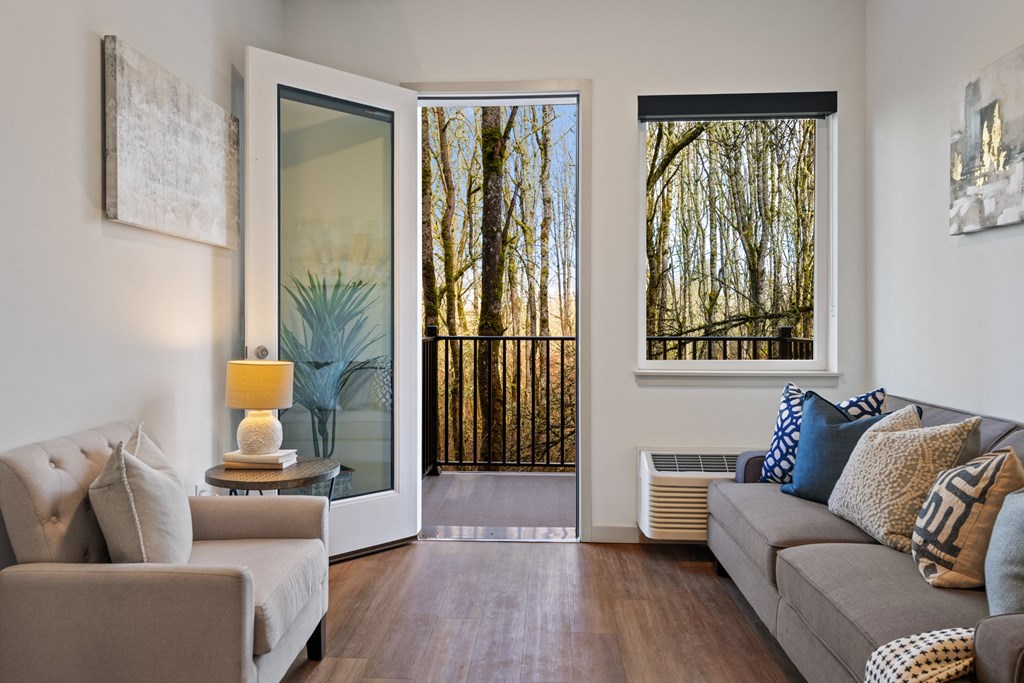 a living room with a couch and a door to a balcony