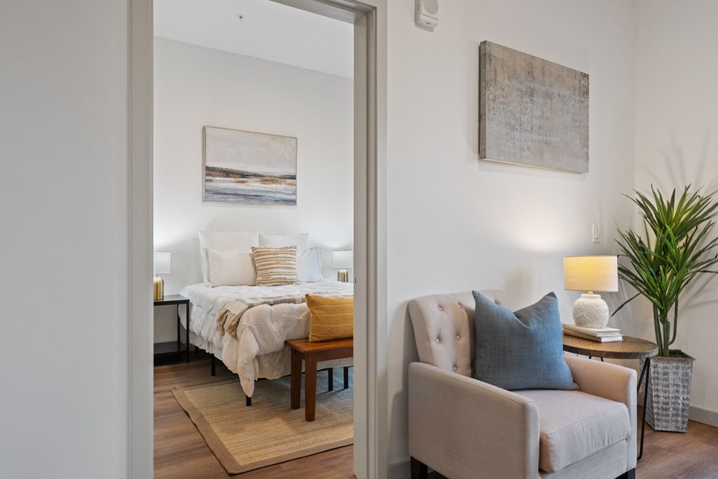 a bedroom with a large bed and a living room with a couch