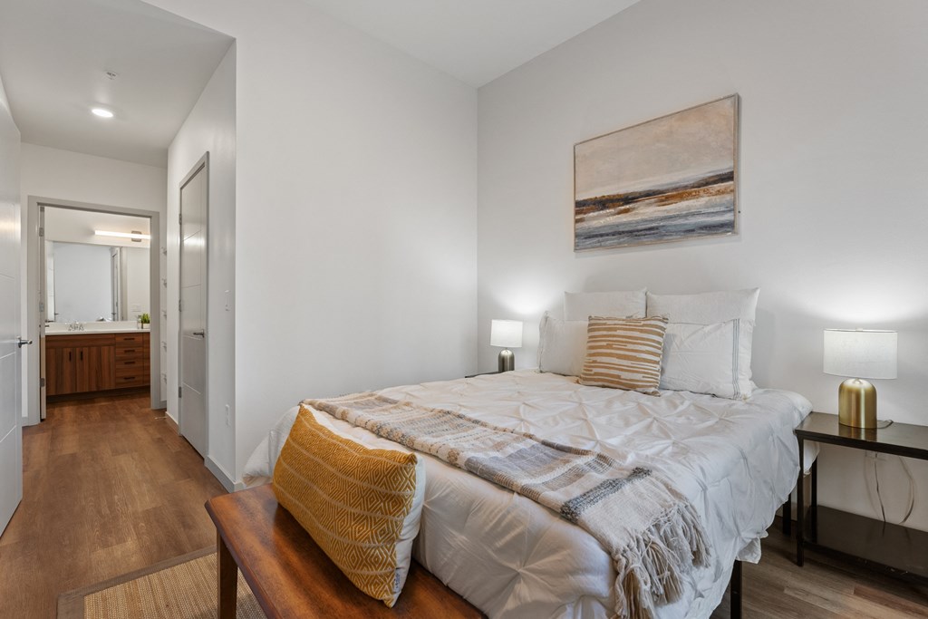 a bedroom with a large bed and a bathroom