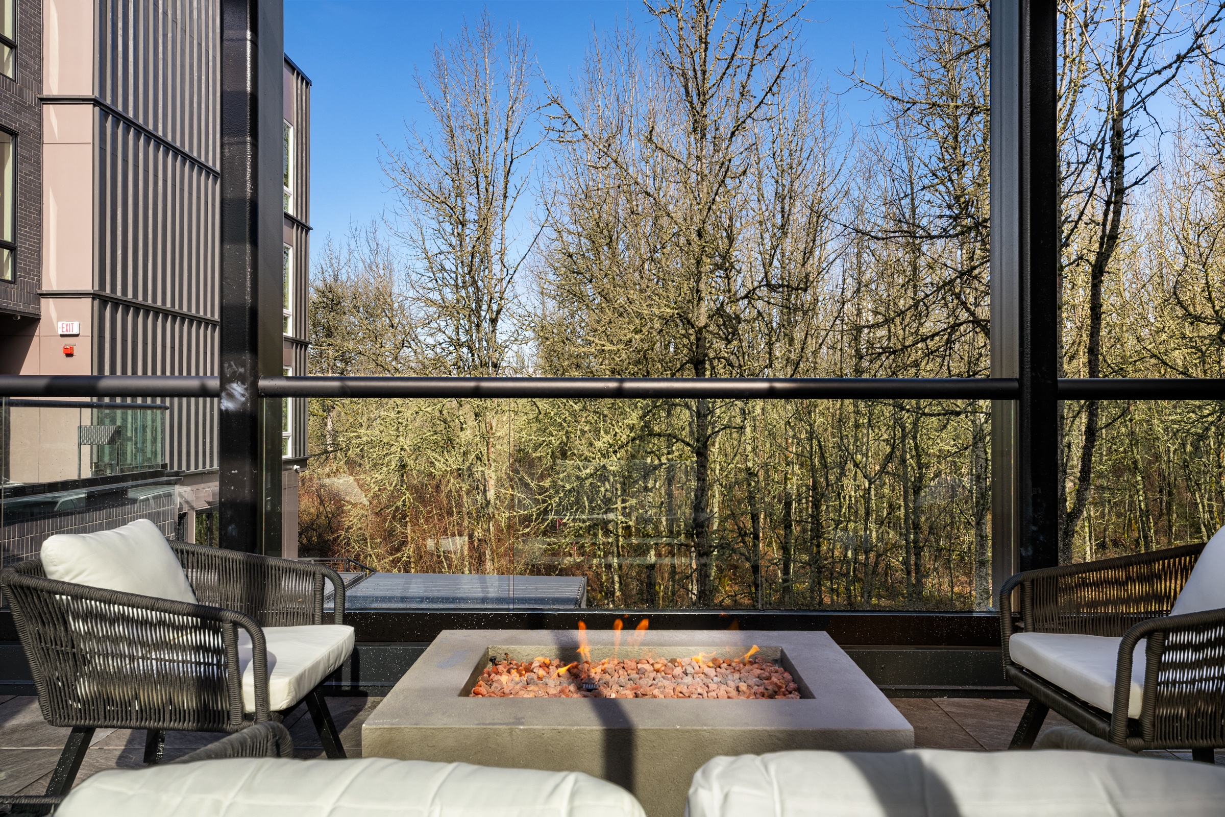 a living room with a large window and a fire pit
