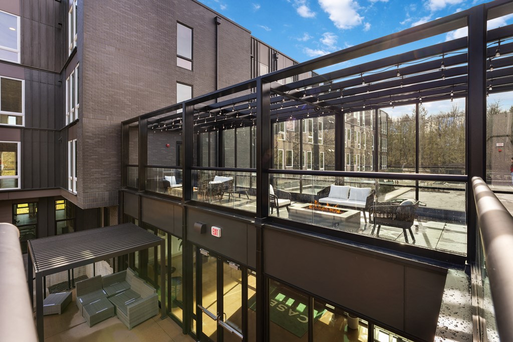 a balcony with a seating area and a patio with tables and chairs