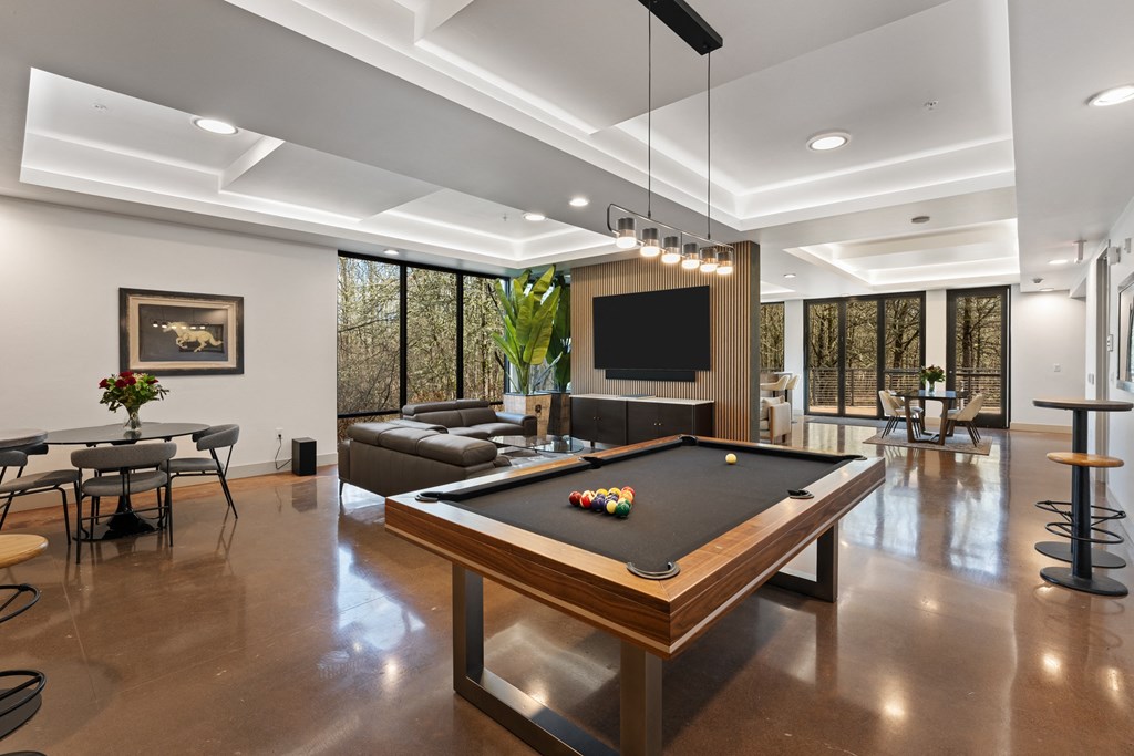 a living room with a pool table and a television