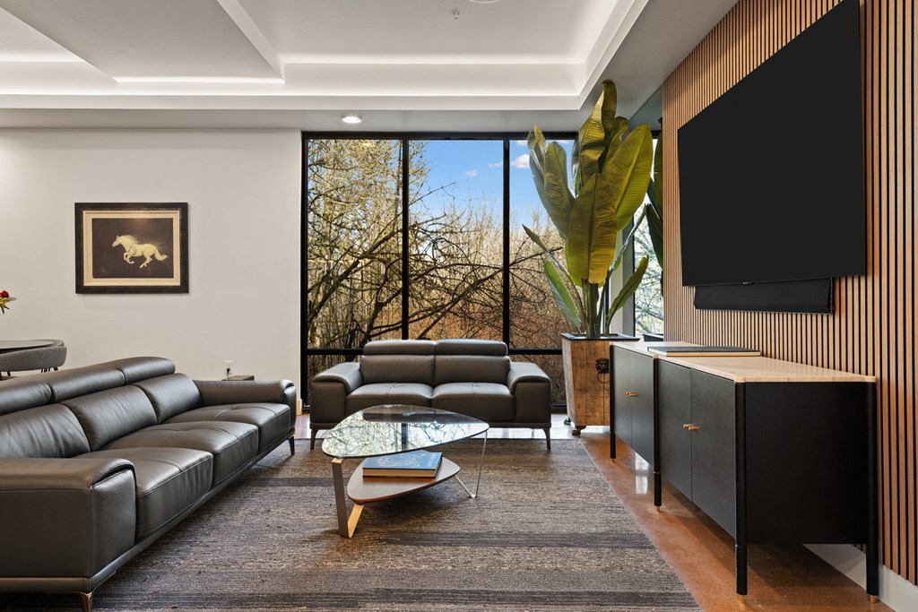 a living room with leather couches and a television