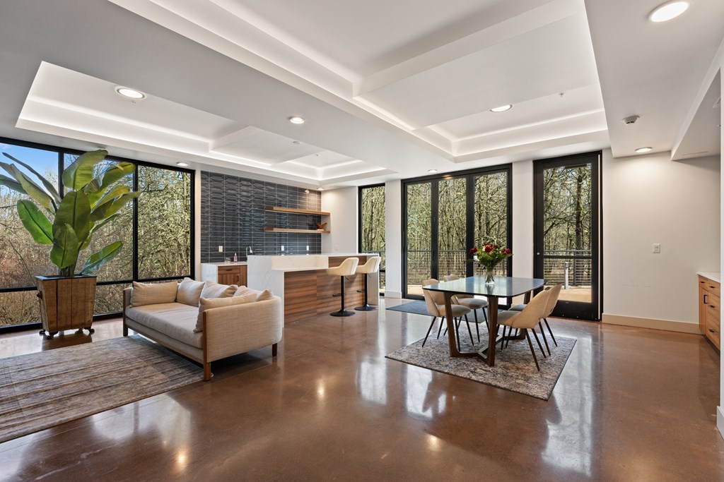 A large living room with a dining table and kitchen and couch
