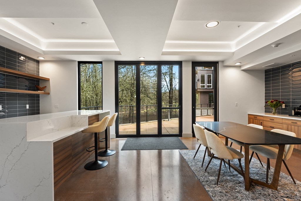 a large kitchen and dining area with a table and chairs and sliding glass doors
