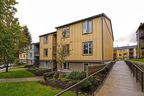 A long building with a walkway in front.
