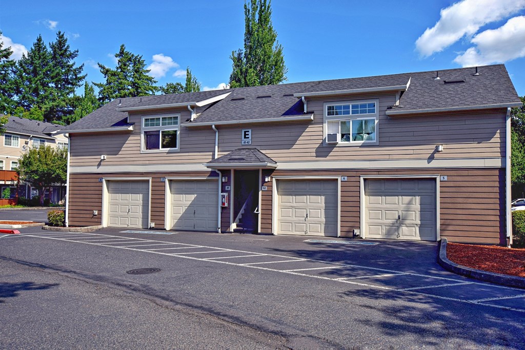 a large building with multiple garage doors in a parking lot