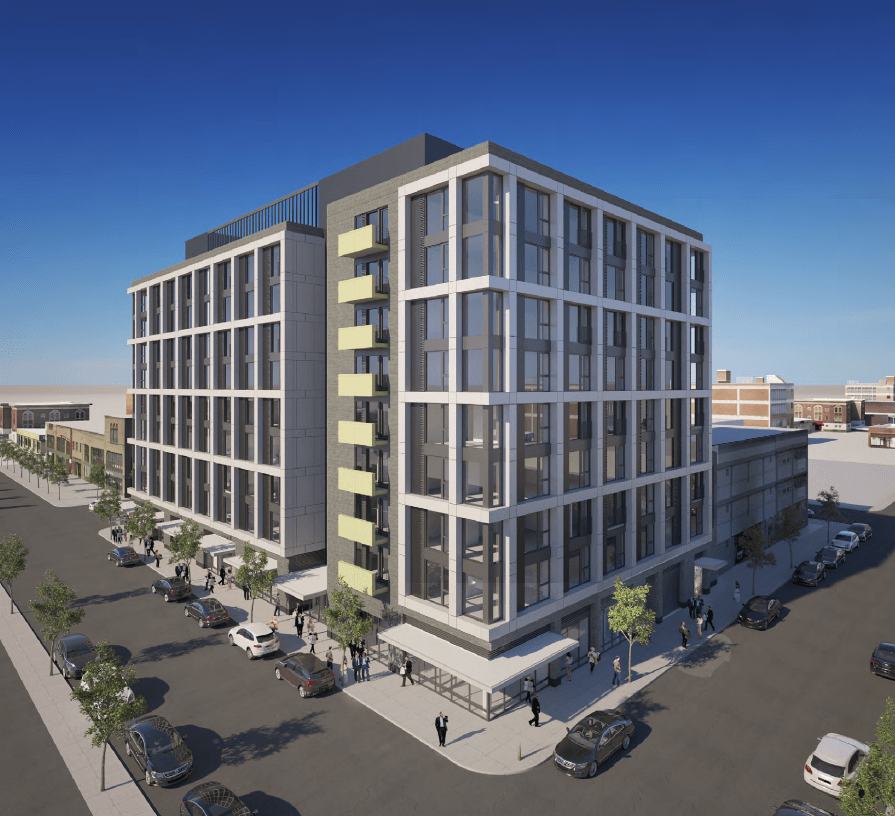 A modern building with a parking lot in front.