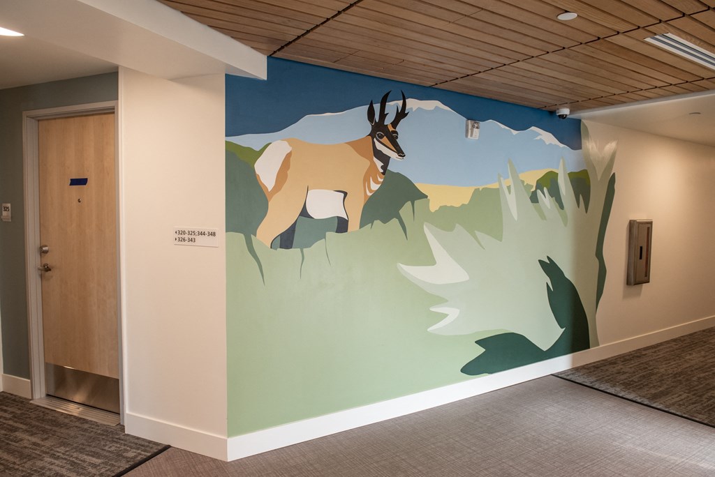 a mural of a goat on the wall of a hallway