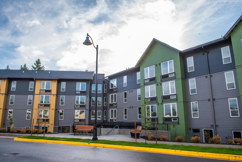 a row of new apartment buildings on the side of a street