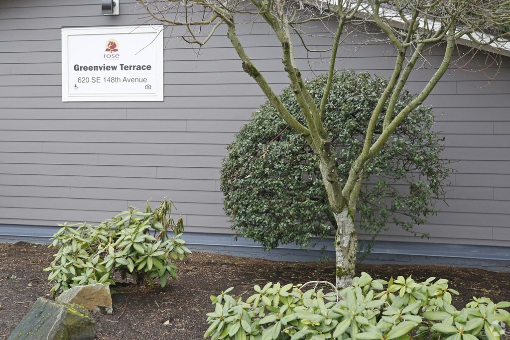 A sign for Greenview Terrace is mounted on a wall.