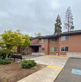 a brick building with a bench in front of it