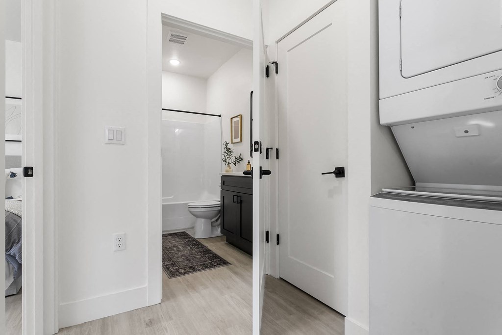a white bathroom with a toilet and a sink