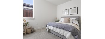 a bedroom with a bed and a window