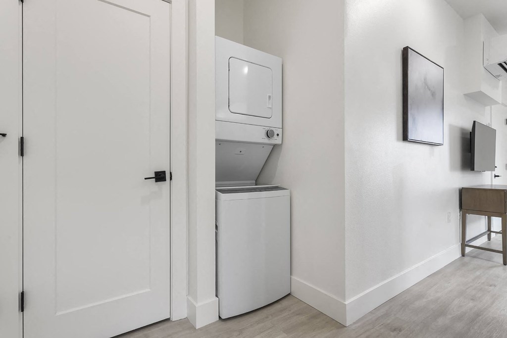a room with a refrigerator and a washing machine in it