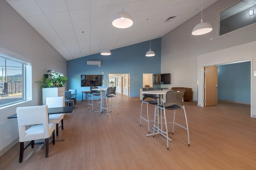 A room with a long table and chairs.