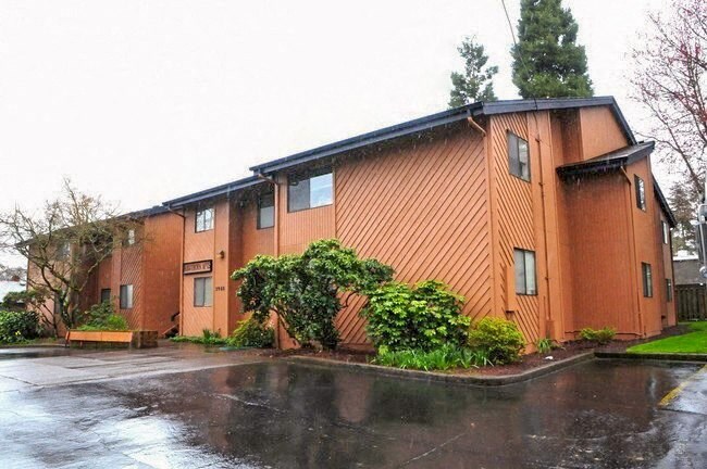 an apartment building with a rain soaked street