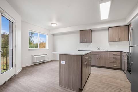 A kitchen with wooden cabinets and a refrigerator.