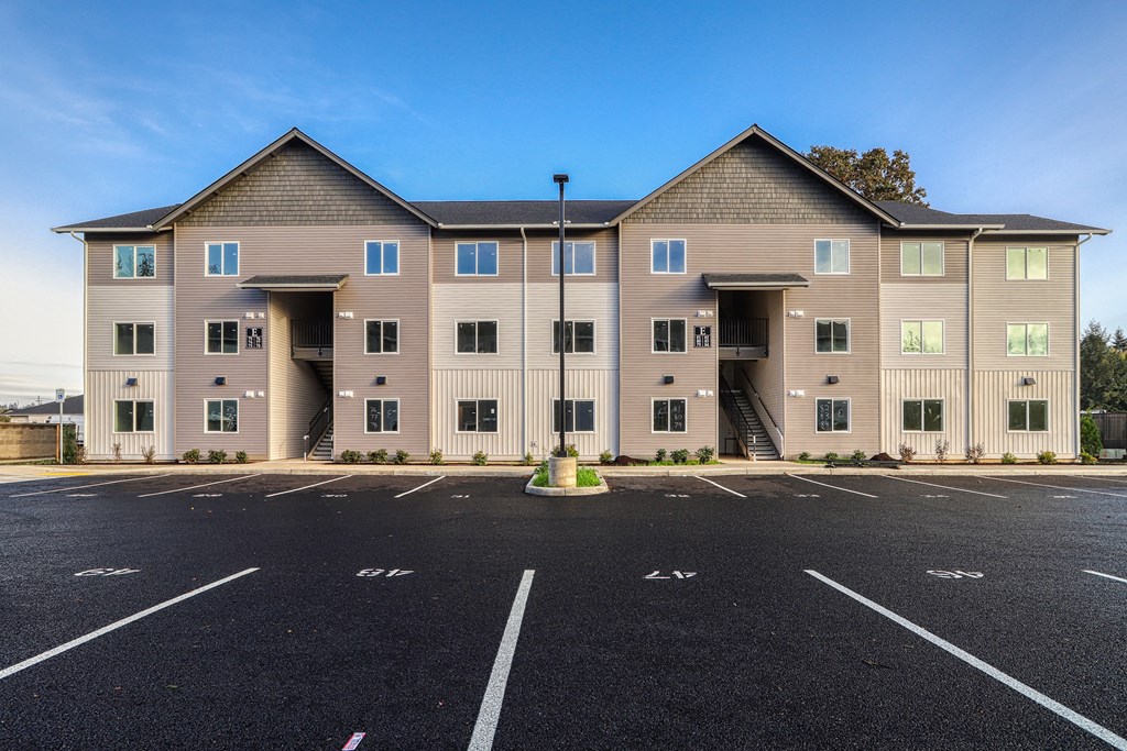 A large building with a parking lot in front of it.