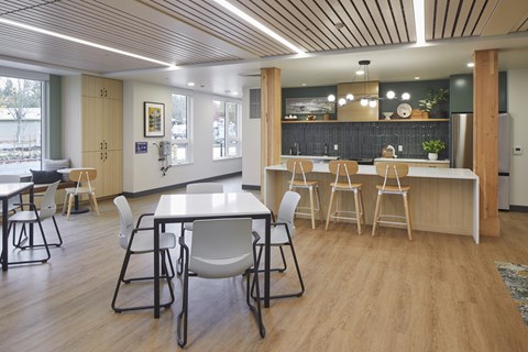 A modern dining area with a long table and chairs.