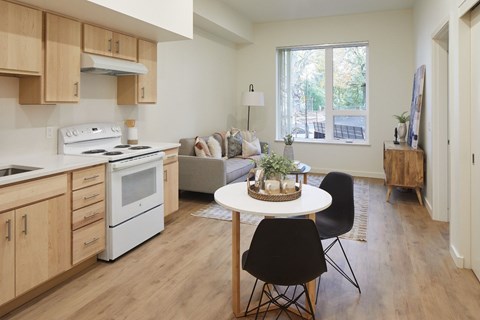 A kitchen with a white stove top oven and a white microwave.