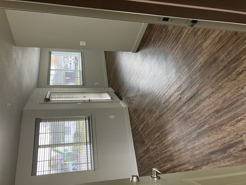 an overhead view of a staircase with a window and a wooden wall