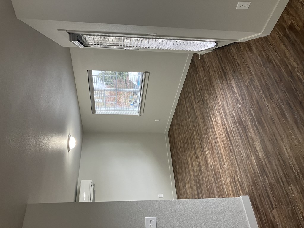 an overhead view of a living room with wood floors and a window