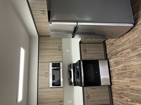an overhead view of a kitchen with a refrigerator and a microwave