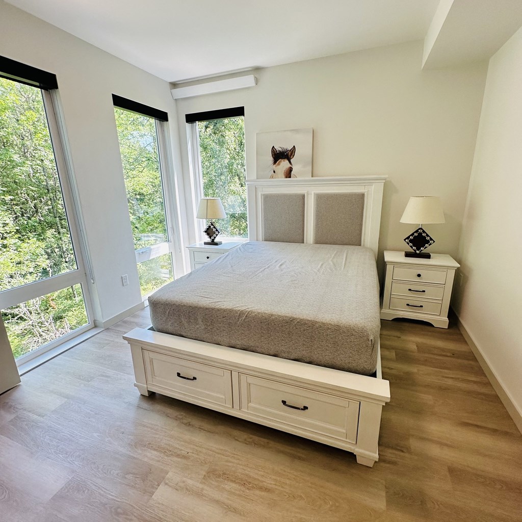 a bedroom with a bed and a window