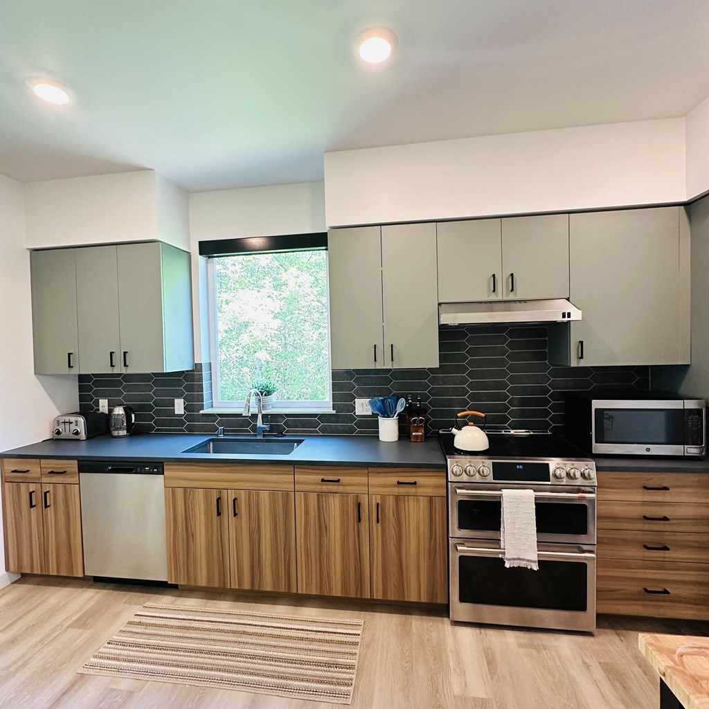 a kitchen with white cabinets and a blue counter top