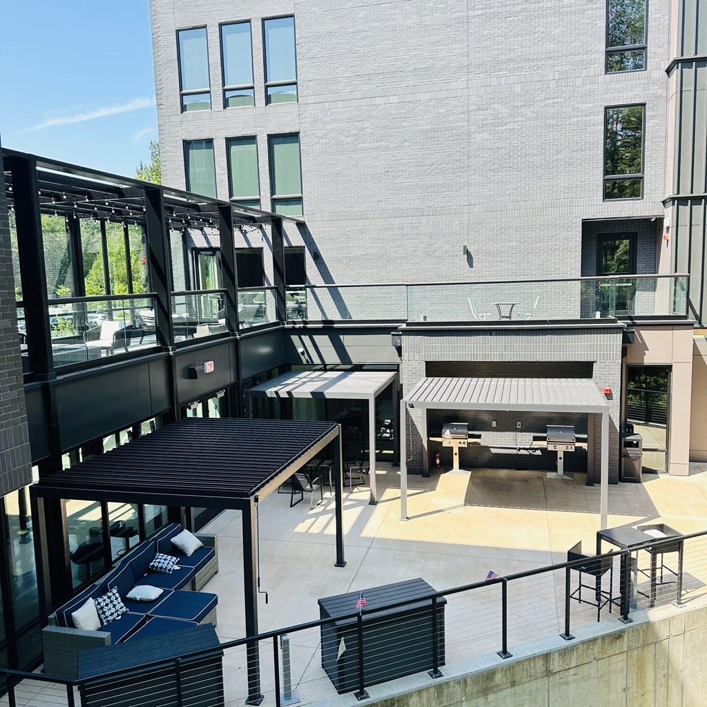 a view of the courtyard of a building with stairs and tables