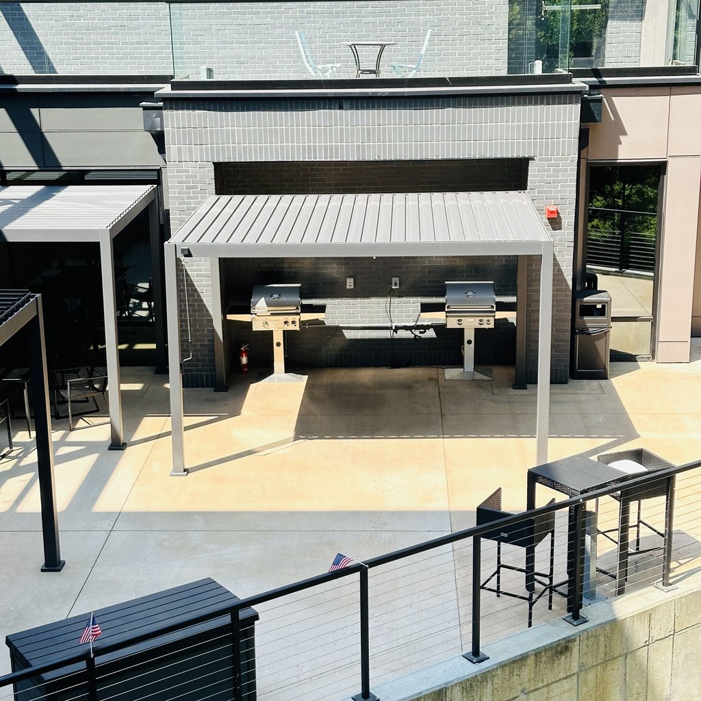 the outside of a restaurant with two outdoorzers and tables