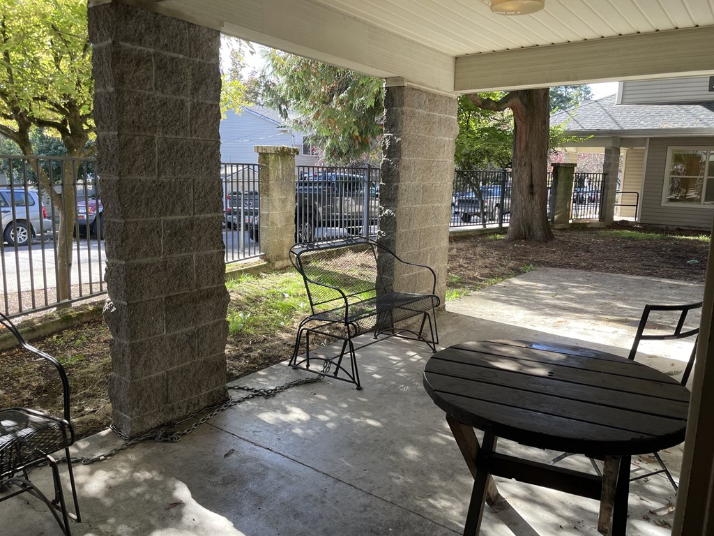 A patio with a table and chairs is shown.