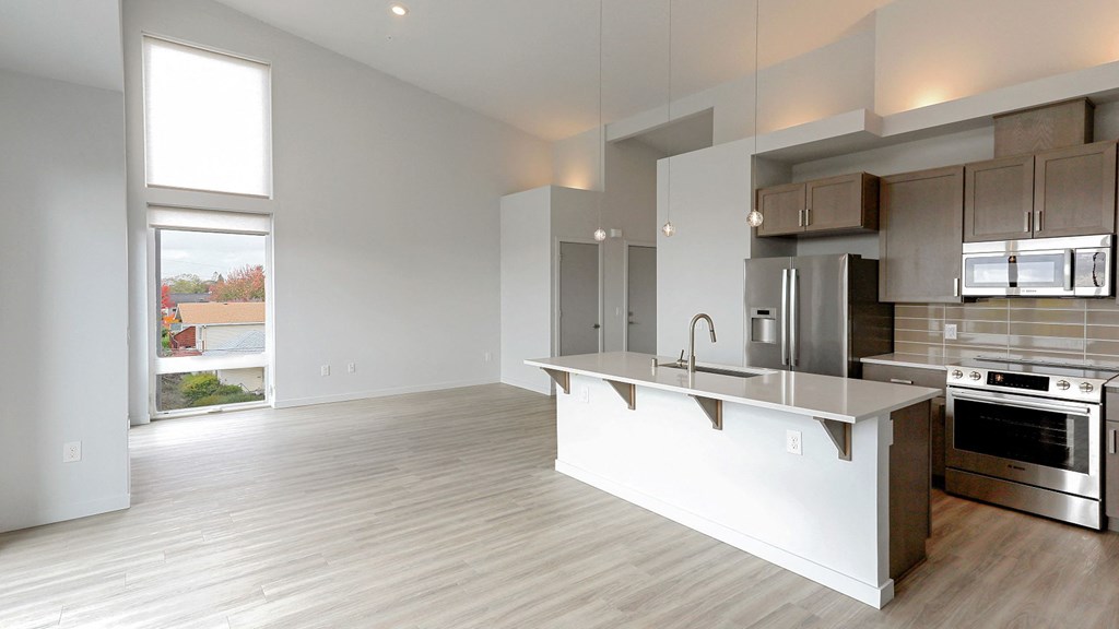 an empty kitchen with an island in the middle