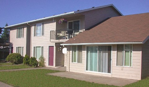 A building with a red door and a balcony with flowers.