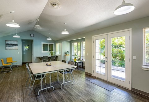 A conference room with a long table and chairs.