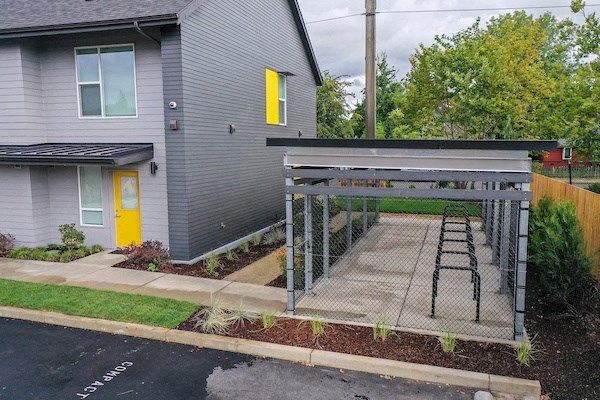 a backyard batting cage in front of a house