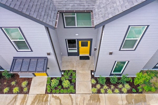 an aerial view of a house with a yellow door