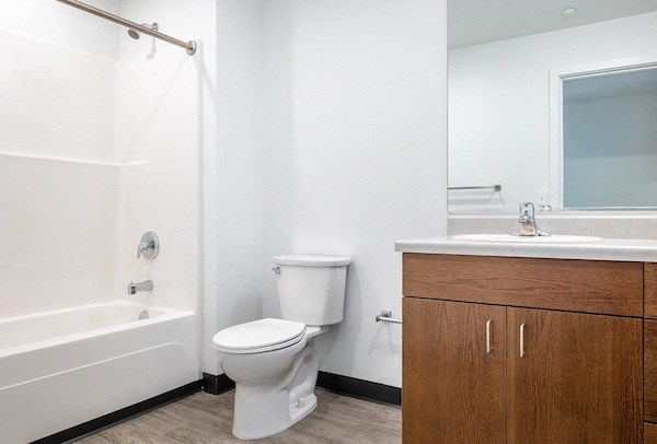 a bathroom with a toilet and a sink and a shower