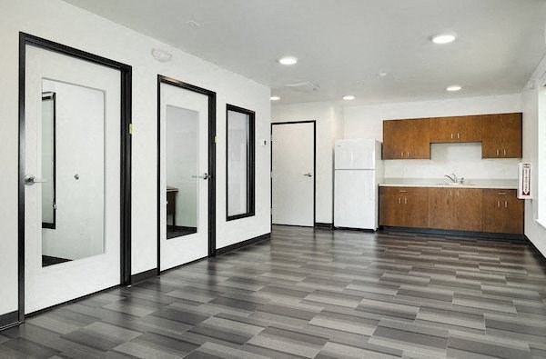 a empty room with white appliances and doors