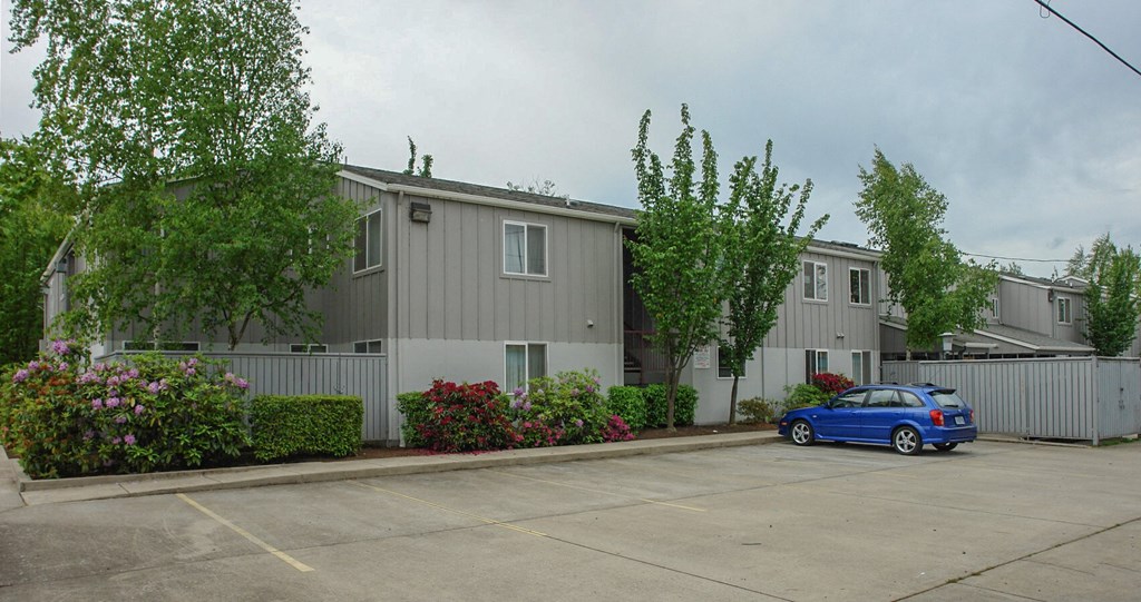 a car parked in front of an apartment building